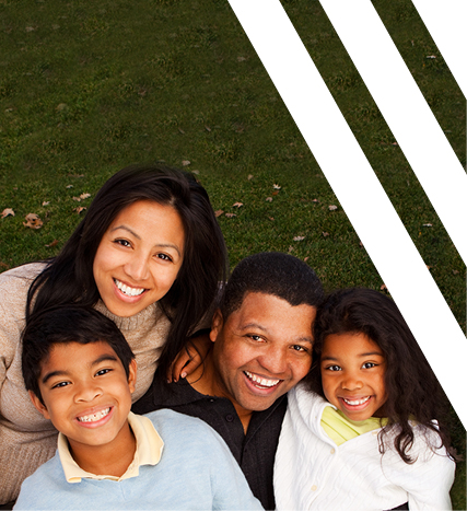 family smiling on grass